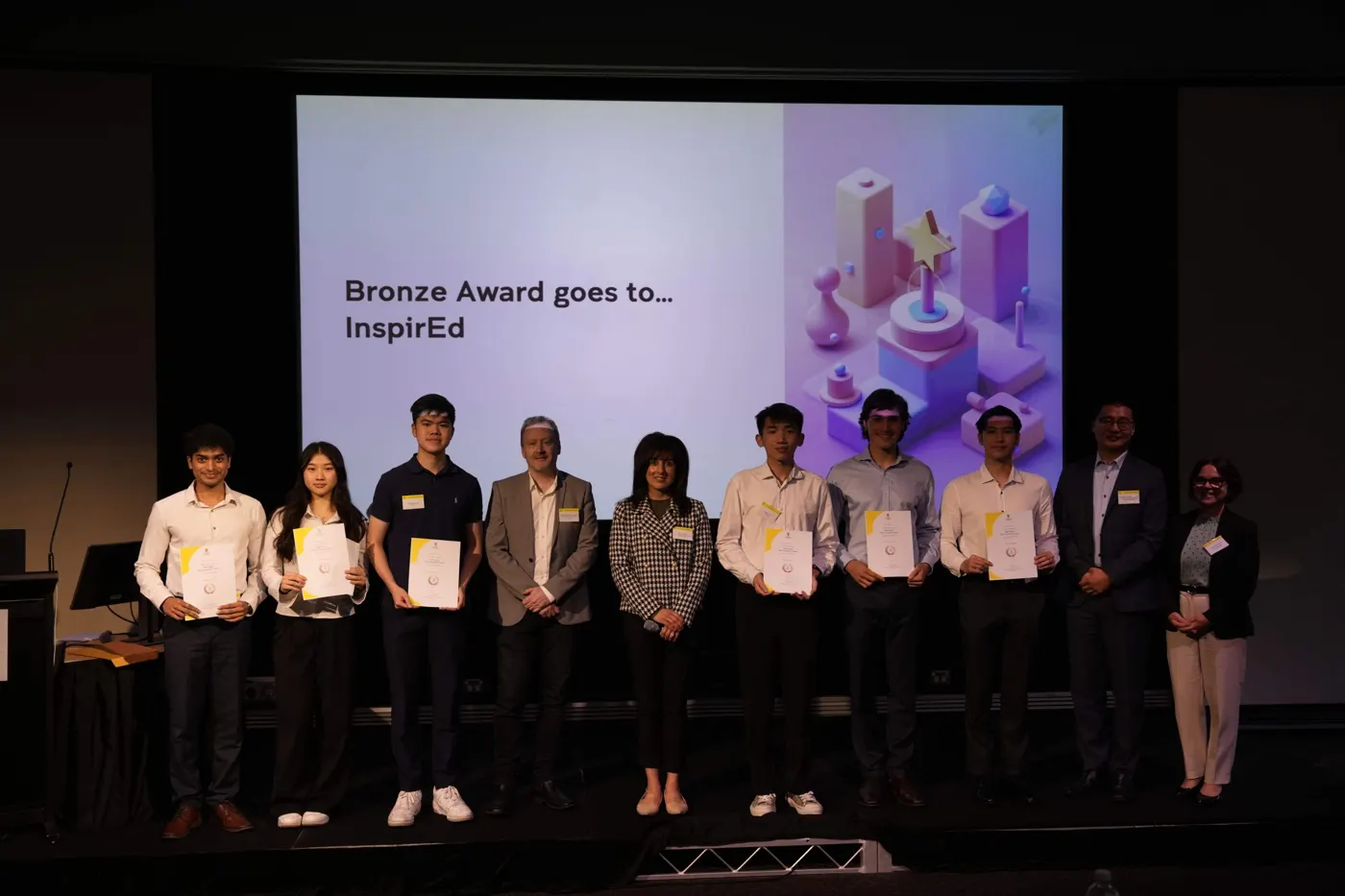 Team InspirEd on stage receiving the Bronze Award at the UNSW INFS3605 Innovation and Transformation Showcase