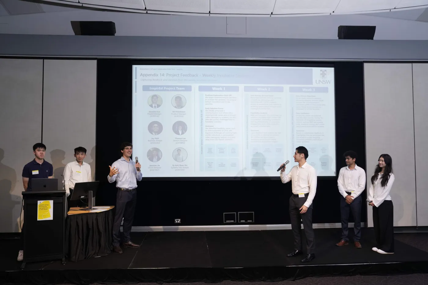 Team InspirEd presenting the solution slides on stage